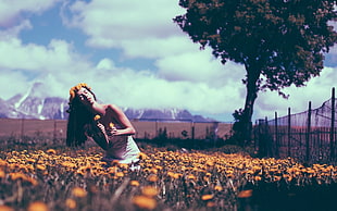woman in bed of flowers near fence during daytime HD wallpaper