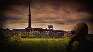 respirator mask near brown building, architecture, factories, chimneys, abandoned HD wallpaper