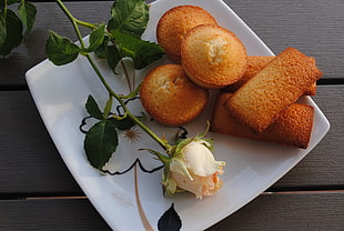 photo of muffins and pink rose on white ceramic plate