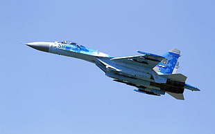 white and blue fighter jet