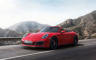 red Porsche 911 convertible on concrete road HD wallpaper