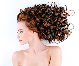 portrait photography of woman with long curly brown hair