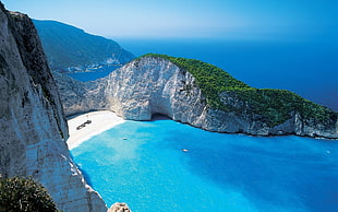 green island with blue sea during daytime