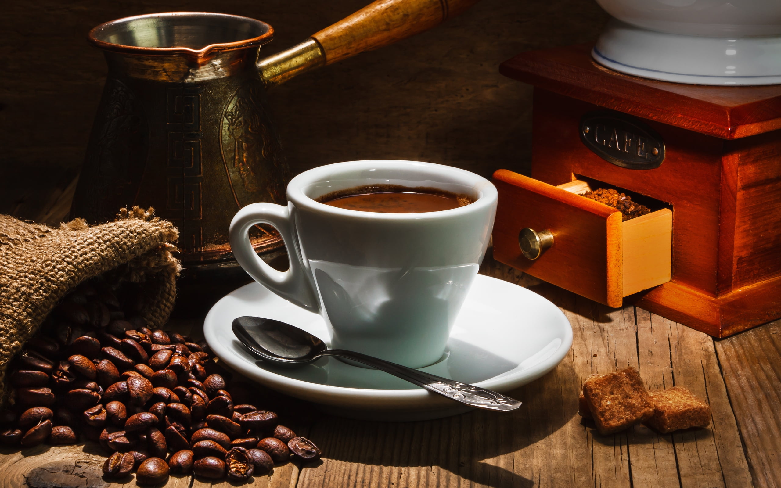 white ceramic teacup with brown liquid