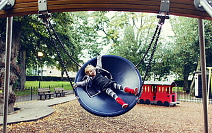 boy in blue jacket swinging on round dome swing HD wallpaper