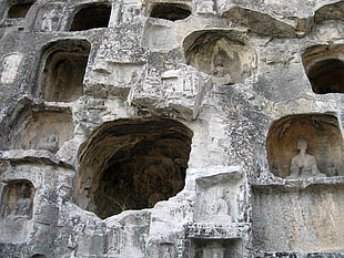 gray concrete temple with Buddha statues