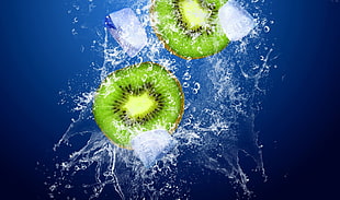 two sliced kiwi fruit submerge in water HD wallpaper