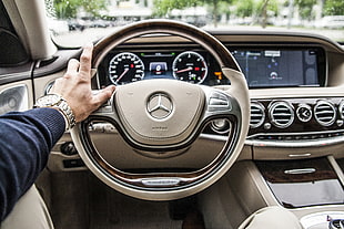 person taking photo of grey Mercedes-Benz steering wheel HD wallpaper