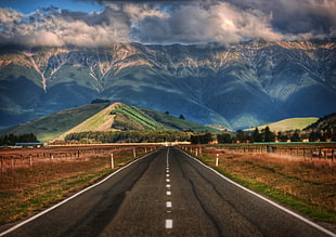 empty asphalt road across mountains