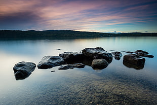 rock formation surrounded by clear water on late at daytinme HD wallpaper