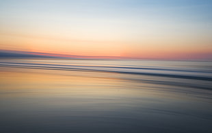 body of water during sunset