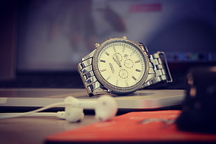 selective focus photo of round silver-colored chronograph watch with link band HD wallpaper
