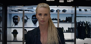 blonde haired woman in black top standing near glass display shelf HD wallpaper