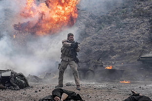 men's gray tactical vest and black assault rifle HD wallpaper