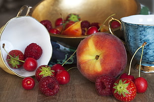 still life photography of red apple and strawberries on brown wooden surface HD wallpaper
