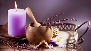 purple lighted pillar candle beside a brown mortar and pestle on the tray HD wallpaper