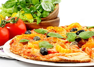 thin crust pizza with black olives and green vegetables beside two orange tomatoes HD wallpaper