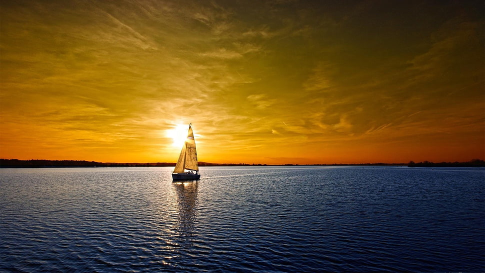 sailing boat on body of water during sunset HD wallpaper