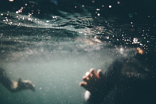 underwater photo of person in black shirt