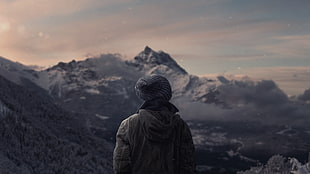 person wearing knit hat looking at mountain HD wallpaper