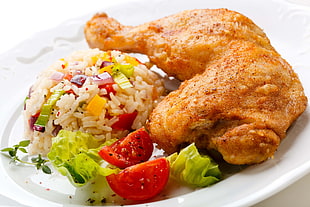 fried rice with salad and fried chicken on white ceramic plate