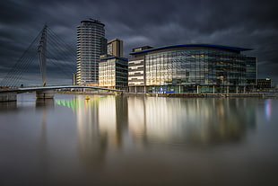 gray and white glass wall building near body of water and bridge, salford quays HD wallpaper