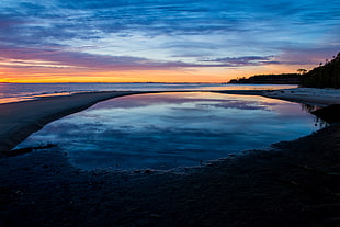 landscape photography of island near body of water