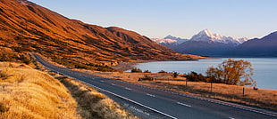 photo of gray asphalt road surrounded with brown mountains near body of water during day time, mt cook HD wallpaper