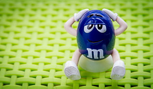 blue M&M figurine holding head HD wallpaper