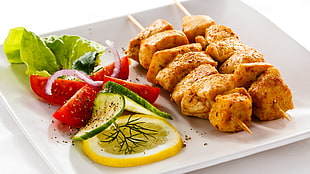 barbecue with slice lemon and letos on white ceramic plate