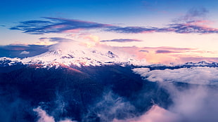 snow covered mountain over the clouds HD wallpaper