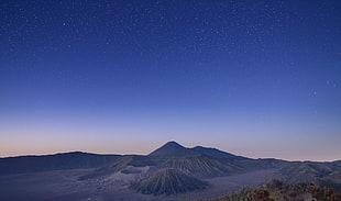 gray coated mountain during night timne