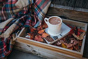 white ceramic teacup with brown coffee