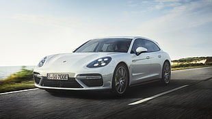 white Porsche Panamera running on road by the sea HD wallpaper