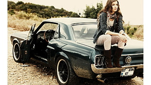 woman sitting in black Ford Mustang Fastback HD wallpaper