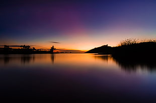 body of water during sunset