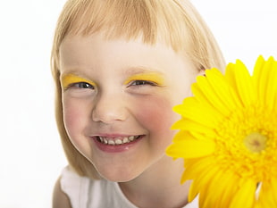 smiling girl holding yellow Gerbera flower HD wallpaper