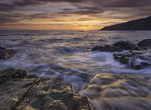 photo of sea waves and rock formation during golden hours, porth HD wallpaper