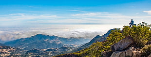 photography of man sitting on mountain, california HD wallpaper