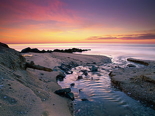 body of water during sunset