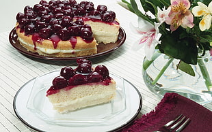 sliced cheese cake serving on white ceramic plate