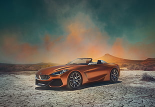 orange-metallic convertible coupe on dessert sand HD wallpaper