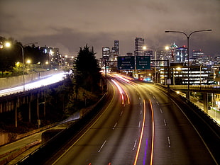 time lapse photography of passing cars in rose during nightime