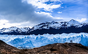 two person standing on mountain top