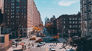 aerial view of street crossing in between buildings during daytime