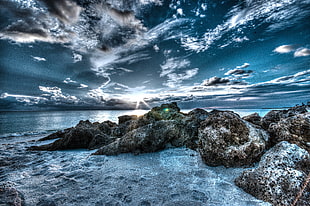 3D photography of beach rocks under clouds transformation during daytime