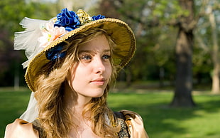 girl in brown sun hat with trees and grass field in the background HD wallpaper