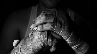 person wearing boxing bands grayscale photo