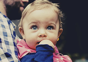 baby wearing blue and pink long-sleeved top