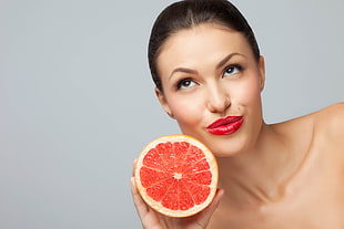 woman holding orange sliced fruit HD wallpaper